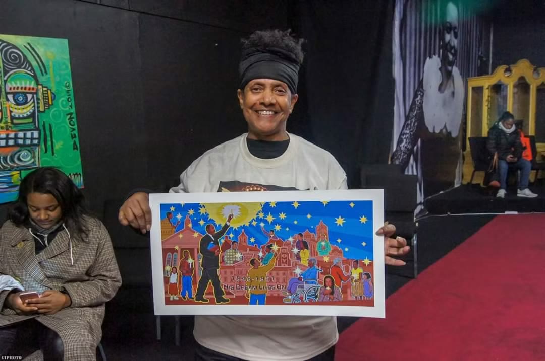 Twyla Simpkins holding an illustrated work about Chester history